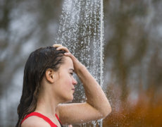 Kvinde tager et friluftsbad i sit ude-badeværelse